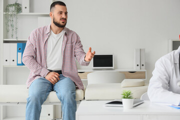 Young man visiting doctor in clinic. Prostate cancer awareness concept