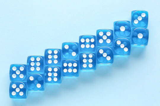 Many blue game dices on color background