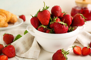 Bowl with sweet ripe strawberries on white background, closeup