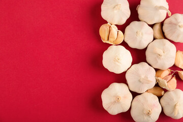 Fresh garlics on red background