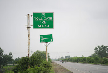 toll gate ahead road sign india, highway toll plaza signboard chhattisgarh, green toll gate direction sign on road, national highway toll information board, road travel route with toll gate ahead. 

