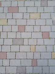 Texture of street tiles. Pattern of gray sidewalk tiles close up