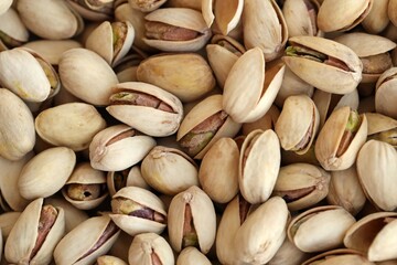 Many tasty unpeeled pistachios top view flat lay background pattern