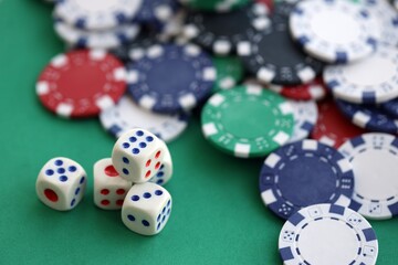 Dice game on the poker table in the casino. A successful combination of dice brought a lot of winning chips