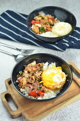 Ricebowl with beef teriyaki and egg served in bowl on the table