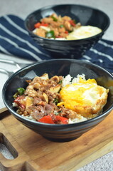 Ricebowl with beef teriyaki and egg served in bowl on the table