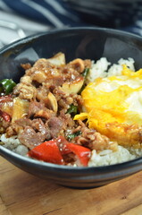 Ricebowl with beef teriyaki and egg served in bowl on the table