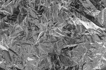 Silver crumpled foil texture on flat surface