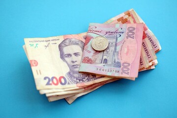 Ukrainian money bills on light blue paper background