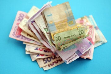 Ukrainian money bills on light blue paper background