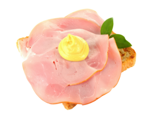 Sliced pink ham on toasted bread with a swirl of yellow mustard and fresh green leaf garnish.