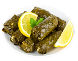 Traditional stuffed grape leaves or dolma garnished with fresh lemon wedges and a sprig of parsley.