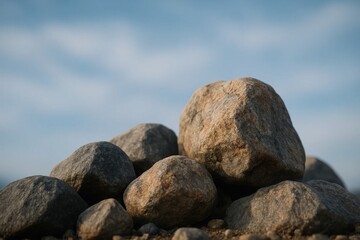 A serene assembly of large, weathered rocks under a vast blue sky