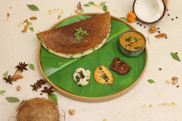 Maysore masala dosa with sambhar and coconut chutney on banana leaf