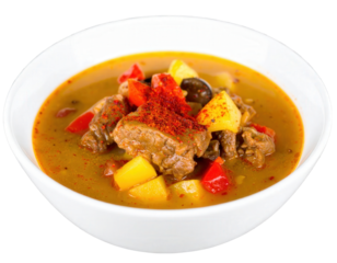 Hearty goulash soup with tender beef potatoes and peppers garnished with paprika.