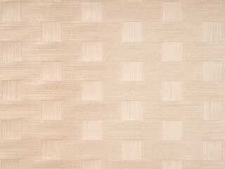 Neutral beige squares on textured veneer surface creating a modern pattern