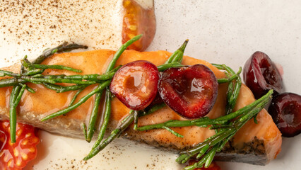 Grilled salmon with vibrant cherries and sea asparagus, an artistic culinary delight, perfect for Bastille Day or International Flavor Day