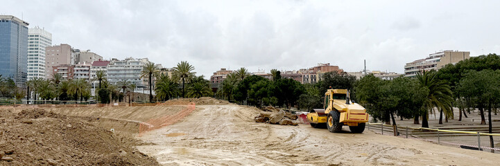 Urban renewal unfolds under a brooding sky, an emblematic dance of progress for Earth Day...