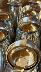 Reflective silver urns glimmer under soft cafe lighting, evoking coffee cult rituals and serene International Peace Day gatherings