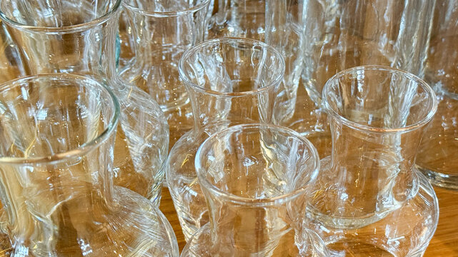 Crystal-clear glass pitchers gather in poetic chaos, reflecting shimmering light, perfect for International Day of Transparency or Vitray Fest
