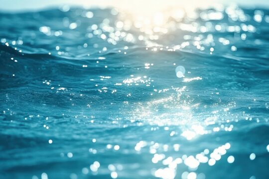 Close-up of ocean water surface with sunlight reflecting and sparkling on gentle waves creating a serene and calming atmosphere