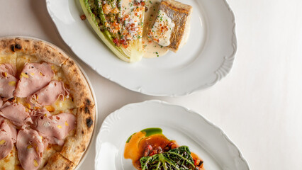 Three decadent plates of Italian cuisine, tantalizing taste buds during La Festa di San Giuseppe, featuring savory porchetta pizza bliss