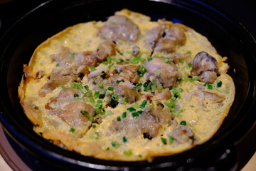 oyster omelette served in black dish, Chinese food