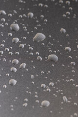 silver colored metal surface covered with water, wet silver-colored metal painted to protect aluminum alloy and metals, close up