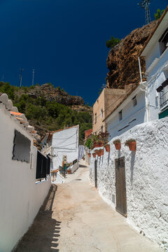 Town street decorated with flowers, in Molinicos village, Castilla la Mancha, Spain.