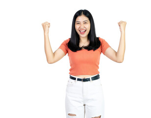 Obraz premium Joyful young Asian woman with a wide smile celebrating success with raised fists.
