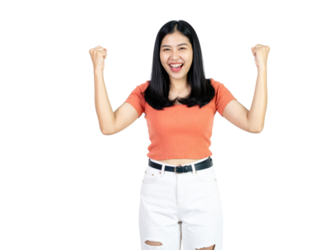 Joyful young Asian woman with a wide smile celebrating success with raised fists.
