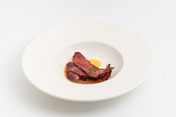 Barbecue pork slices with hard-boiled egg in a savory brown sauce