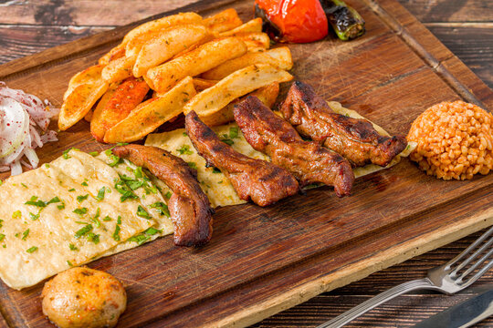 Grilled lamb fillet or Lamb Kusleme served with fries, lavash bread and bulgur pilaf