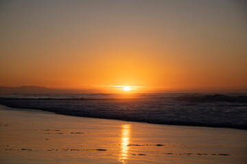 Fototapeta premium Sunrise over the beach at Jeffreys Bay, South Africa