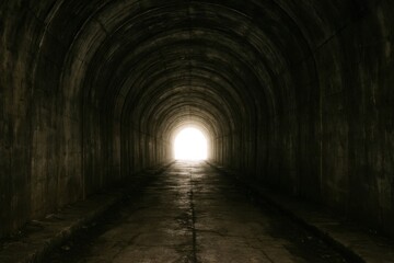 A solitary beam of light pierces through a dark tunnel, casting eerie shadows on the stone floor