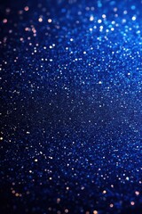 Close-up of sparkling blue glitter particles creating a shimmering and magical textured surface with vibrant light reflections
