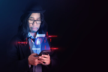 A man in dark clothing using a smartphone with holographic red alerts, depicting cyber attack and digital security threats.