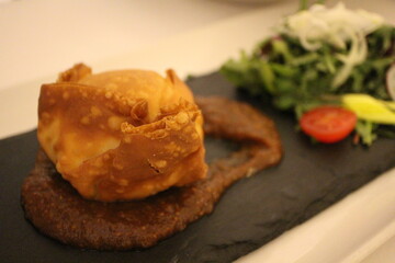 French cuisine: Maltese goat cheese parcel with fig jam and petit salad in Valletta, Malta