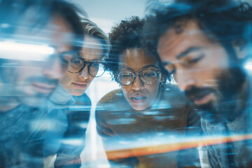 Close-up of diverse colleagues intently focused on a screen together meeting business