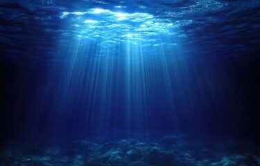 Fototapeta premium Sunlight rays penetrating deep clear blue ocean water illuminating the rocky seabed with a serene and peaceful atmosphere