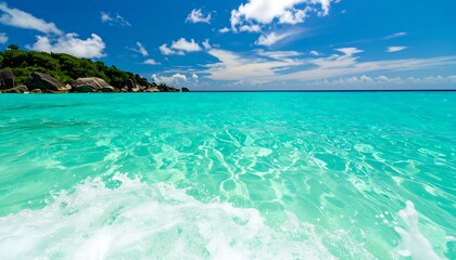 Fototapeta premium Turquoise ocean waves lapping a tropical shore.