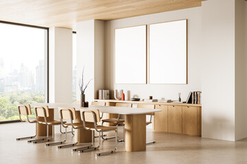 Modern meeting room interior with blank poster mockups on wall and minimalist wooden furniture in bright daylight setting. 3D Rendering. 3D Rendering