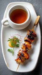 Delicious yakitori chicken skewer with dipping sauce on white plate