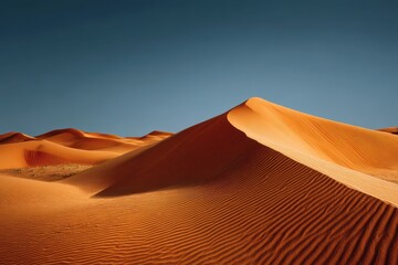 Vast expanse of sand dunes in the Sahara Desert showcasing intricate patterns and warm tones under a clear blue sky during a sunny day