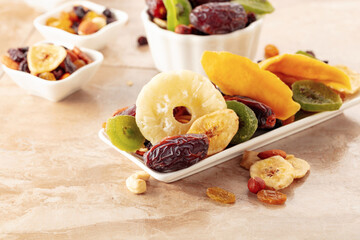 Dried tropical fruits with various nuts and raisins.