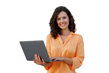 Young professional wearing orange top, typing on laptop with curly hair, working remotely with cheerful expression
