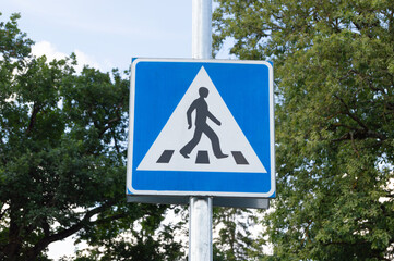 blue road sign pedestrian crossing