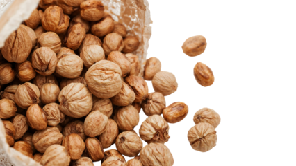 Whole dried walnuts in sack falling on the transparent background, healthy snack, organic food, natural protein, rustic harvest concept