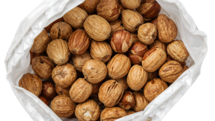 Whole dried nutmegs in white paper bag isolated on the transparent background, aromatic spice, culinary ingredient, natural seasoning