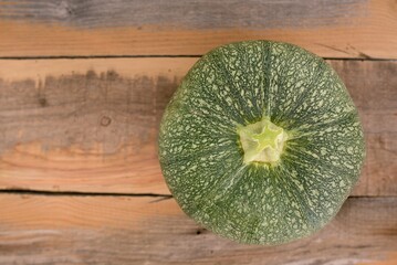 yellow pumpkin on wooden table